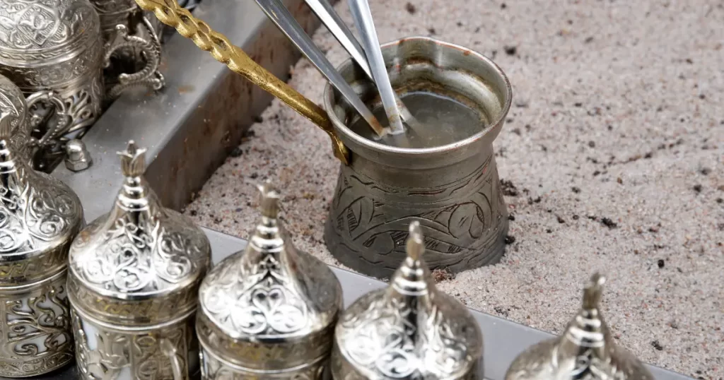 Turkish coffee pot in hot sand